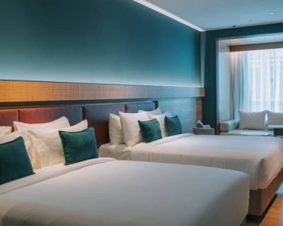 Modern Hotel Room With Double Bed, Night Tables and day sofa bed